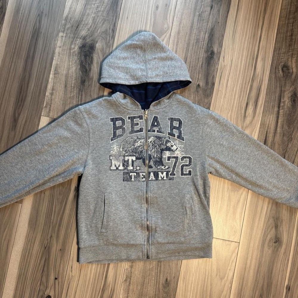 Heavy-duty, double-lined reversible gray zip-up hoodie featuring a bear
